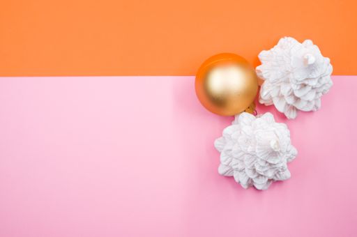 A high angle shot of Christmas ornaments on a colorful surface