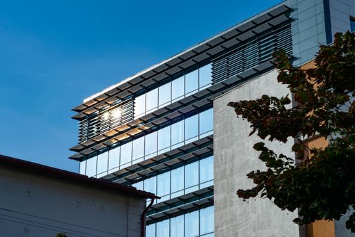 a large-glass building under the blue sky