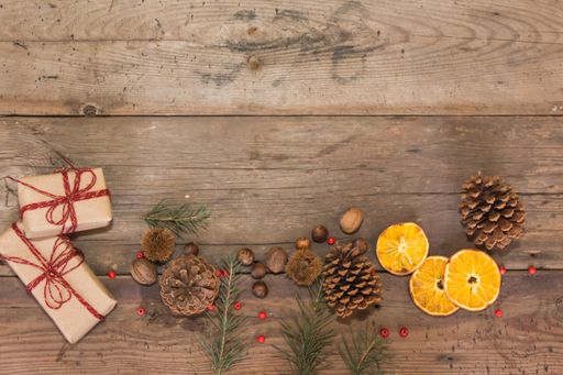 gifts and Christmas decorations on rustic wooden background