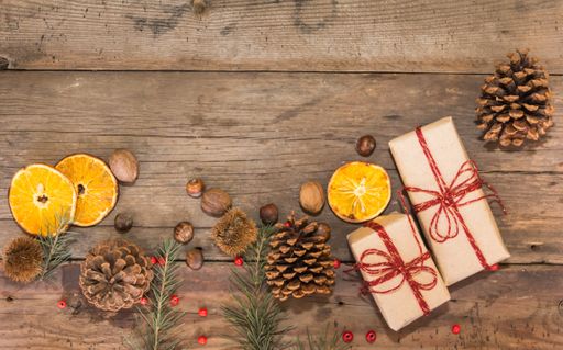 gifts and Christmas decorations on rustic wooden background
