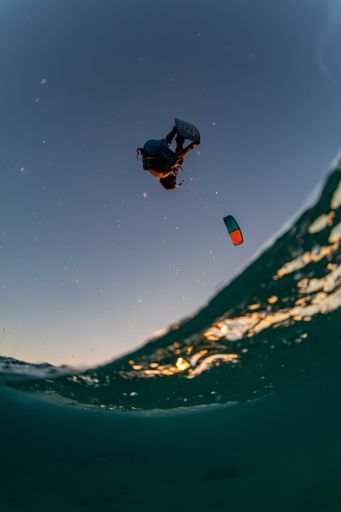 A vertical shot of a brave person kitesurfing in Bonaire, Caribbean