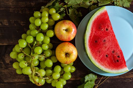 A top view of the sliced watermelon on the plate with other fruits