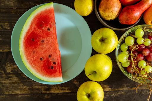 A top view of the sliced watermelon on the plate with other fruits