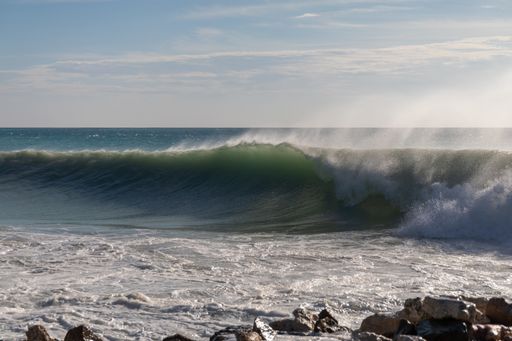 A beautiful scenery of big waves splashing to the ocean shore in Bonaire, Caribbean