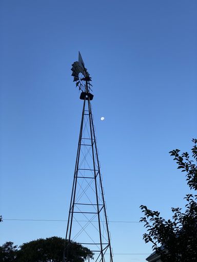 A vertical shot of a cell tower in the evening