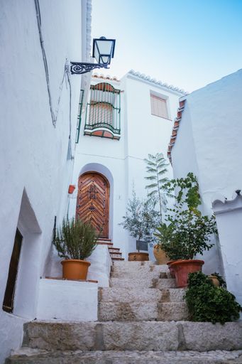 A vertical shot of a house with white exterior walls in Andalusia, Spain