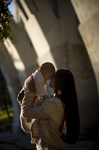 A vertical shot of a Caucasian woman holding her baby girl