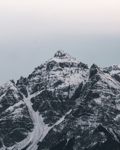 A vertical shot of the beautiful snow covered mountain peaks