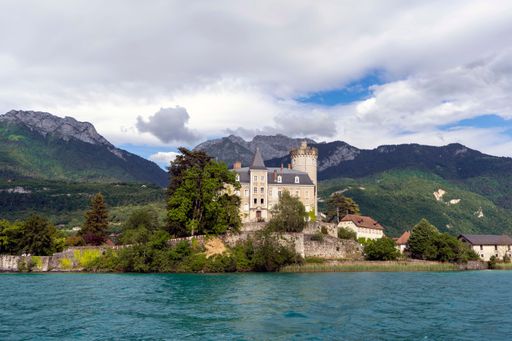 A scenic view of the Duingt Castle located on the shore of the Annecy lake in France