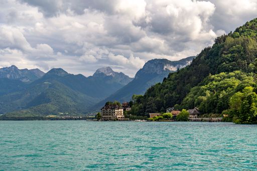 A scenic view of beautiful coastal mountains covered by trees seen on a sunny day