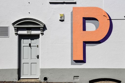 The letter P by artist Gary Stranger on the side of a building in Ditchling. Part of the Village of Type project.