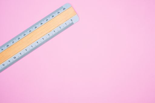 A top view of a colorful ruler isolated on a pink background