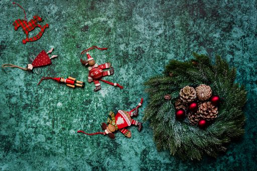 Christmas wreath and ornaments on green background with copy space