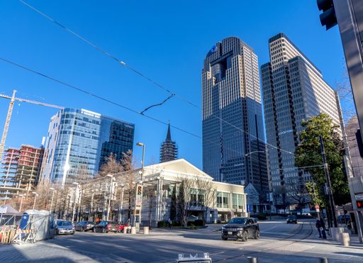 The intersection of North Olive and Flora Streets in Dallas showing skyscrapers and low rise buildings on a fine winters day