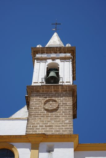 A low angle view of a white church building on a clear blue sky