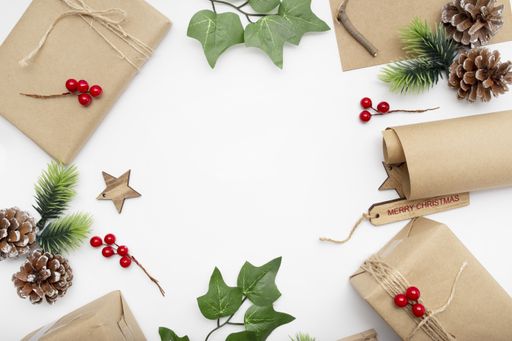 A top view of wrapped gifts, fig branches, pine cones, and  Merry Christmas tag with copy space isolated on a white background