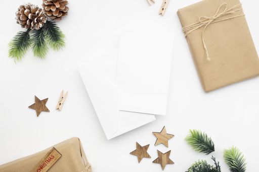 A top view of wrapped gifts, ribbons, fir branches, and pine cones for Christmas with copy space isolated on a white background
