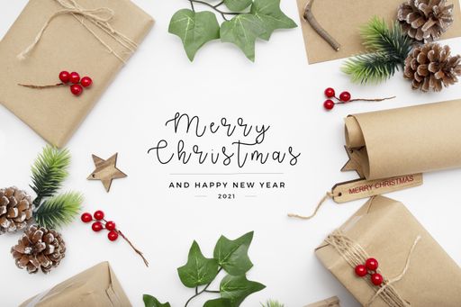 A top view of wrapped gifts and leaves isolated on a white background with a "Merry Christmas" text on it