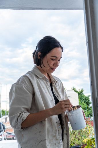 A hispanic woman artist working in the studio