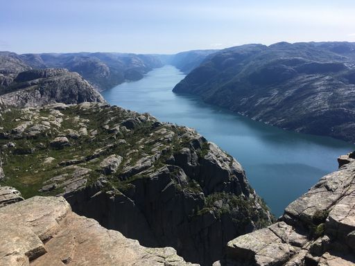 A beautiful shot of a lake surrounded by rock formations under the clear sky