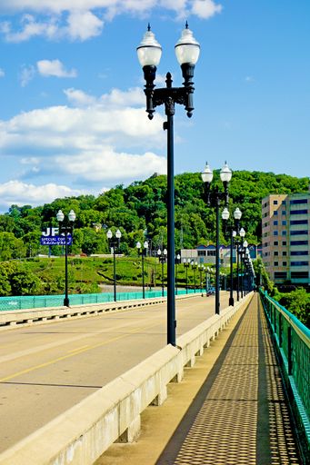 A vertical shot of a Henley bridge road with a row of antique lamp posts in Knoxville, Tennessee