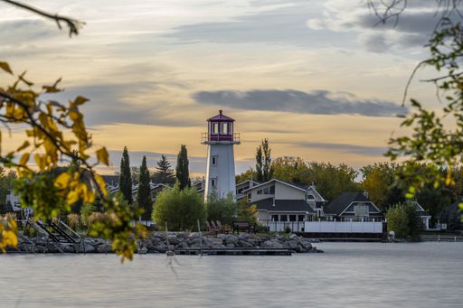 A beautiful shot of the coast with a lighthouse near Sylvan Lake in Alberta, Canada
