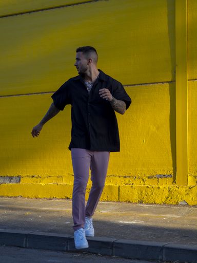 A vertical shot of a young attractive male standing outdoors