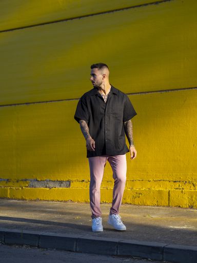 A vertical shot of a young attractive male standing outdoors