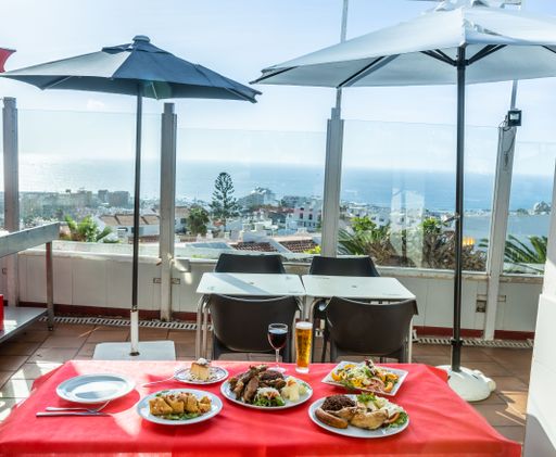 A delicious dinner table on in the balcony of a coastal restaurant with grand view