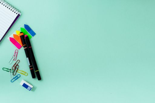 The flat lay of the creative office supplies on the light blue background
