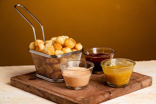A closeup shot of Noisette potatoes with various sauces shot of