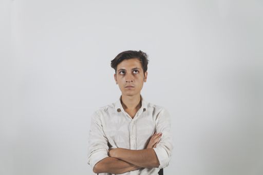 A closeup shot of a handsome pensive young man in a shirt