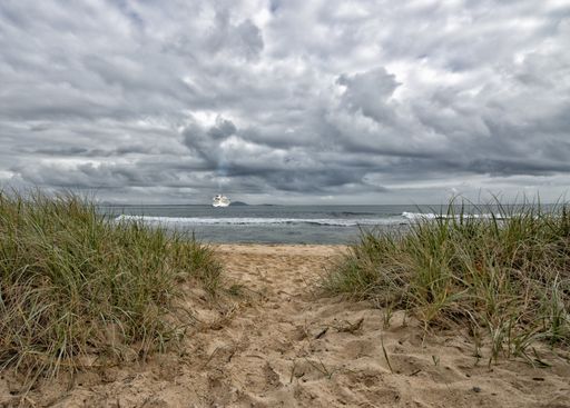 A beautiful shot of an early morning scenery at the beach looking like it is going to rain