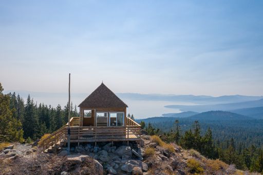 A view of the Martis Peak Fire Lookout with Lake Tahoe in the background photographed from an aerial drone.