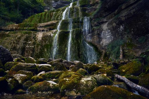 A beautiful view of the moss covered rocks and the waterfalls on the cliffs