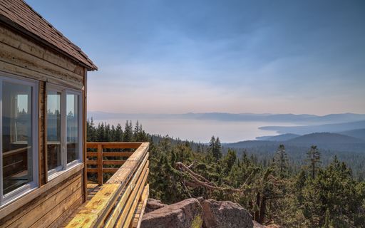 Martis Peak Fire Lookout panoramic views with dramatic skies over Lake Tahoe and the Sierra Nevada mountains.