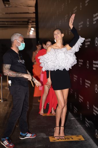 Young model straking a pose before stepping the catwalk in Madrid's Fashion Week 2020