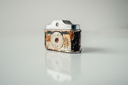 A closeup shot of a rustic classic camera isolated on a white background