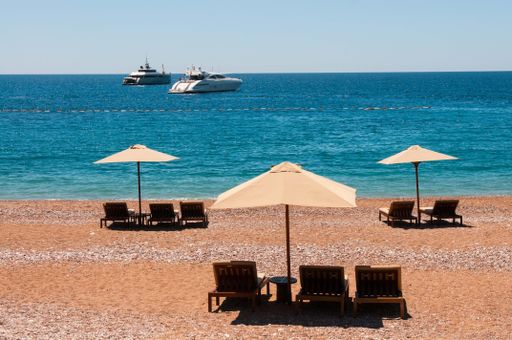 A sandy beach with chairs on a sunny day