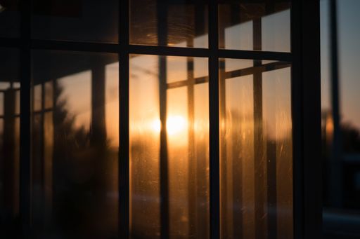 The bright sunset visible through the glass window