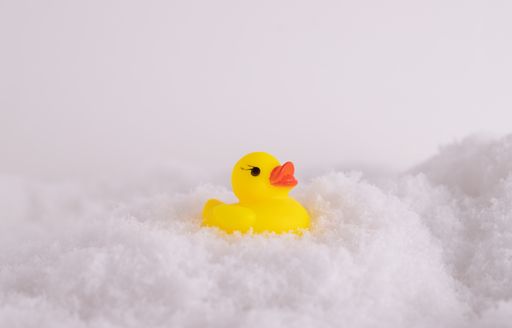 A closeup of a funny rubber duck in the snow