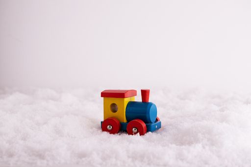 A closeup of a toy train in the snow, educational tool for children