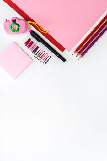 A top view of the office working various tools on the white surface