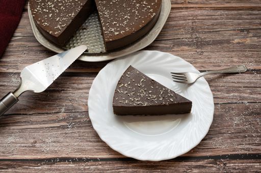 A View Of A Chocolate Cake With A Slice On A Plate