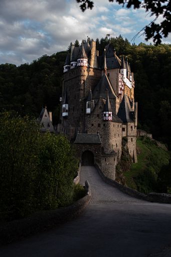 A vertical shot of the beautiful exterior of the Eltz Castle in Wierschem surrounded by lush trees