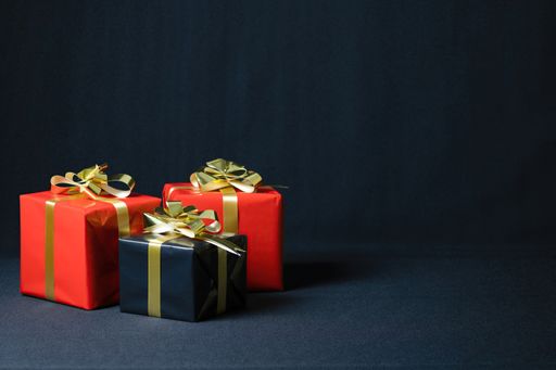 A closeup shot of Christmas gift boxes isolated on a dark background