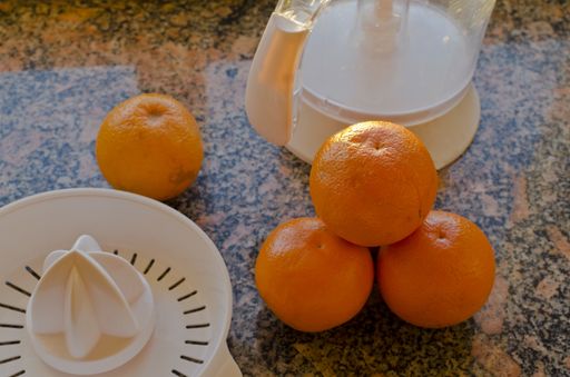 A high angle shot of oranges prepared for juicing on a kitchen counter