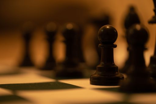 The selective focus shot of the black chess pieces on a chessboard