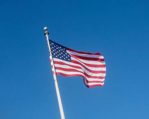 A closeup shot of the waving USA flag on a pole