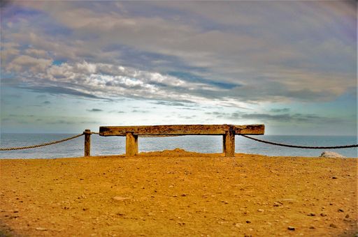 The beautiful view the wooden bench in a beach in Punta de Lobos in Pichilemu, Chile on a sunny day